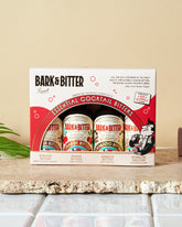 Essential Cocktail Bitters Sampler Kit – 4x1oz non-alcoholic bitters in a beautifully designed retail box featuring Honestly Aromatic, Overtly Orange, and New Orleans Bywater Bitters, plus Remarkable Sparkling Solution.